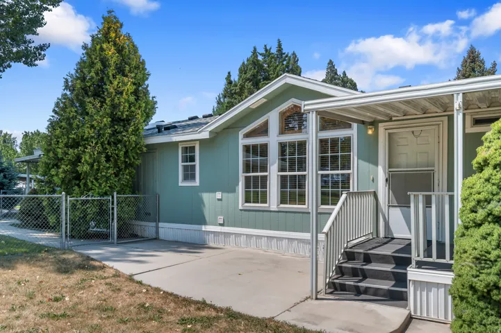 Charming manufactured home featuring a sage green exterior.