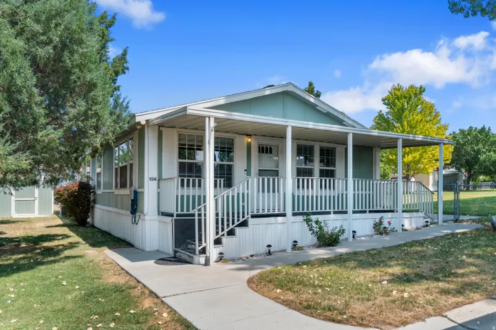 Exterior featuring a covered front porch with white railing.