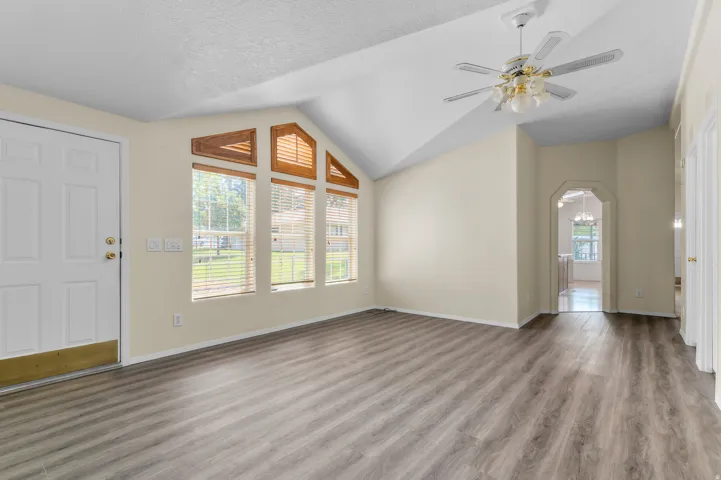 Spacious living area featuring vaulted ceilings.