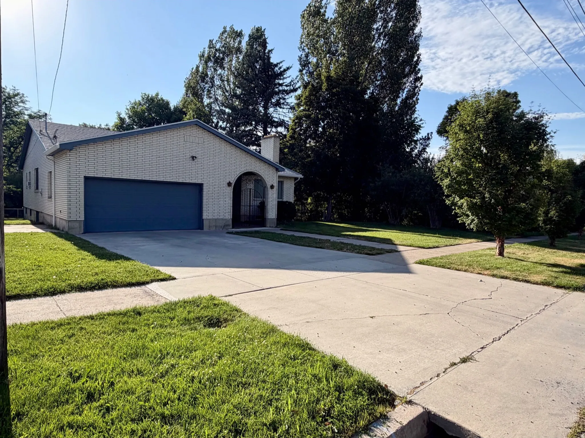 Charming residential property featuring a brick exterior with mature landscaping