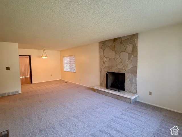 Living room with formal dining at one end flowing into the kitchen
