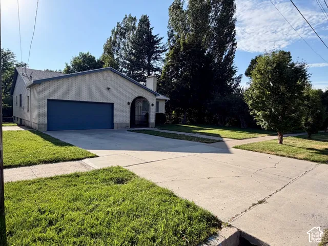 Charming residential property featuring a brick exterior with mature landscaping