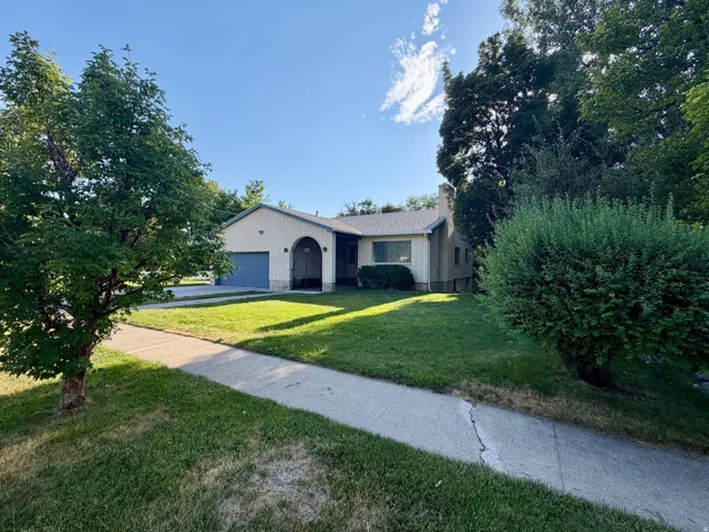 Front of brick home with landscaped yard