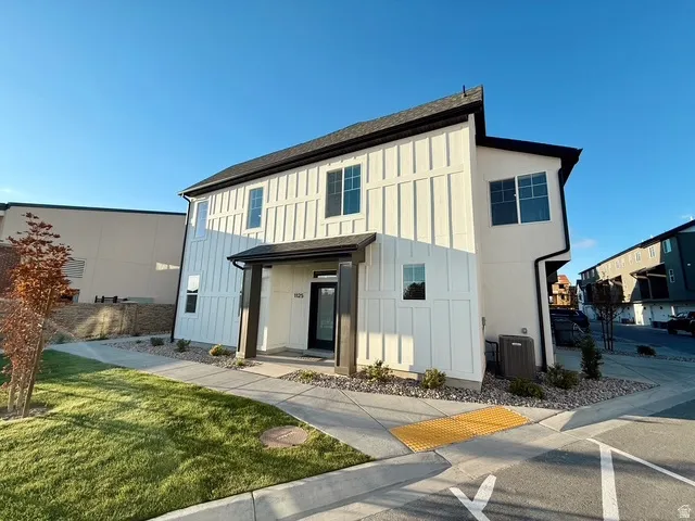 Contemporary facade featuring board and batten siding with stucco accents