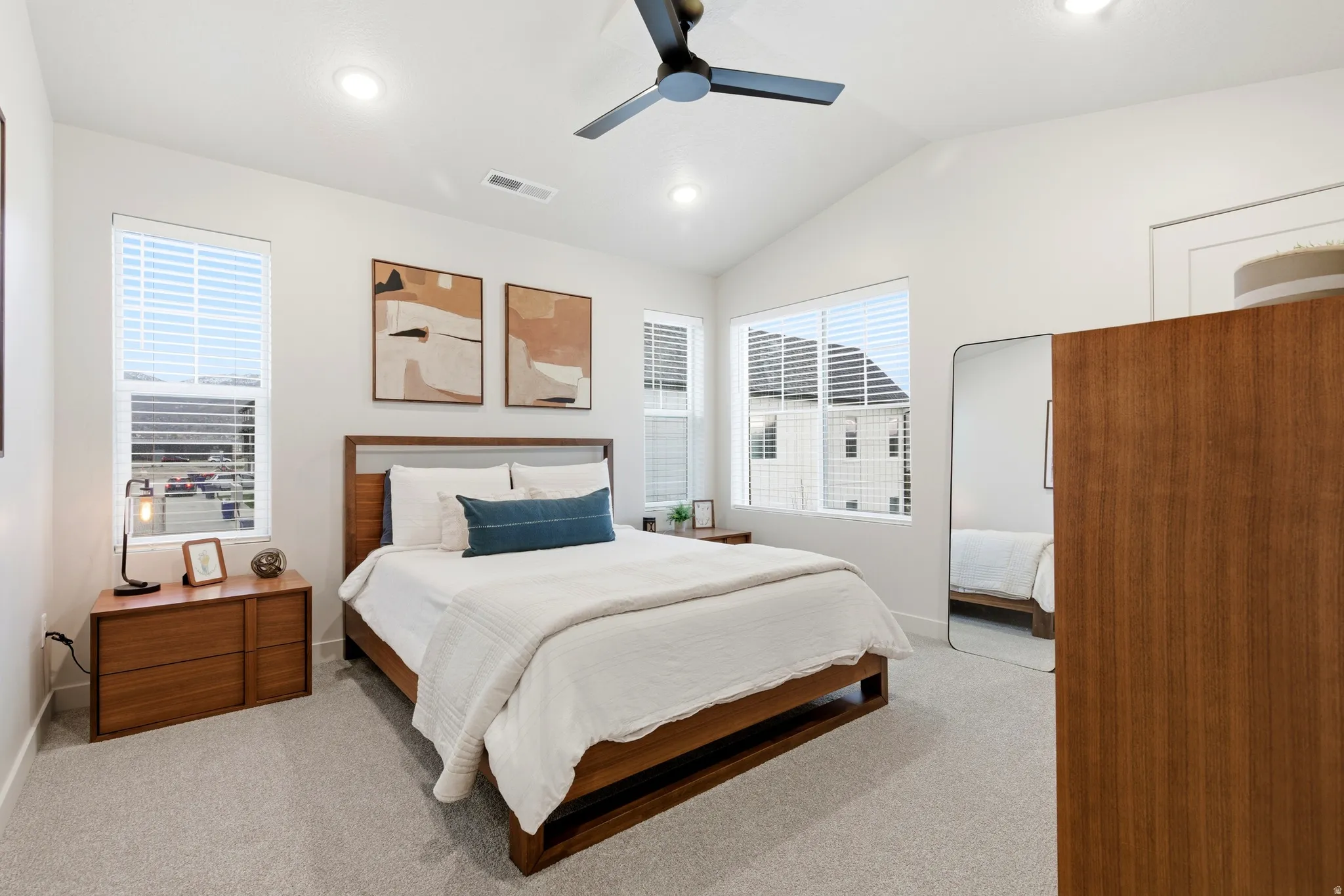Bedroom featuring vaulted ceilings, recessed lighting, ceiling fan, carpet flooring, and multiple windows with blinds