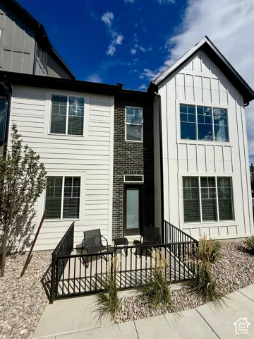 Multi-story exterior with board and batten siding, horizontal siding, and brick accents