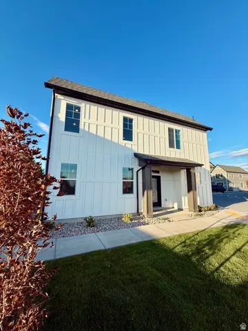 Contemporary facade featuring white vertical board-and-batten siding