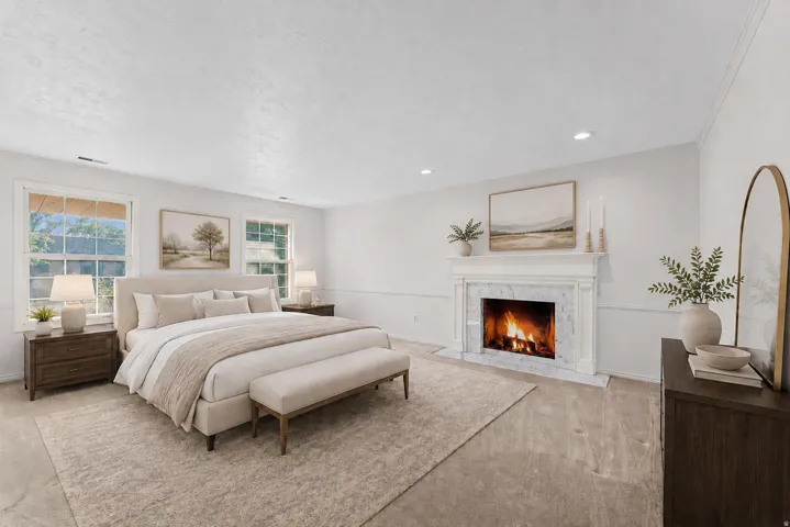 Spacious room featuring a white-mantled fireplace with a marble surround, recessed lighting, two sash windows, and wide plank wood-finish flooring