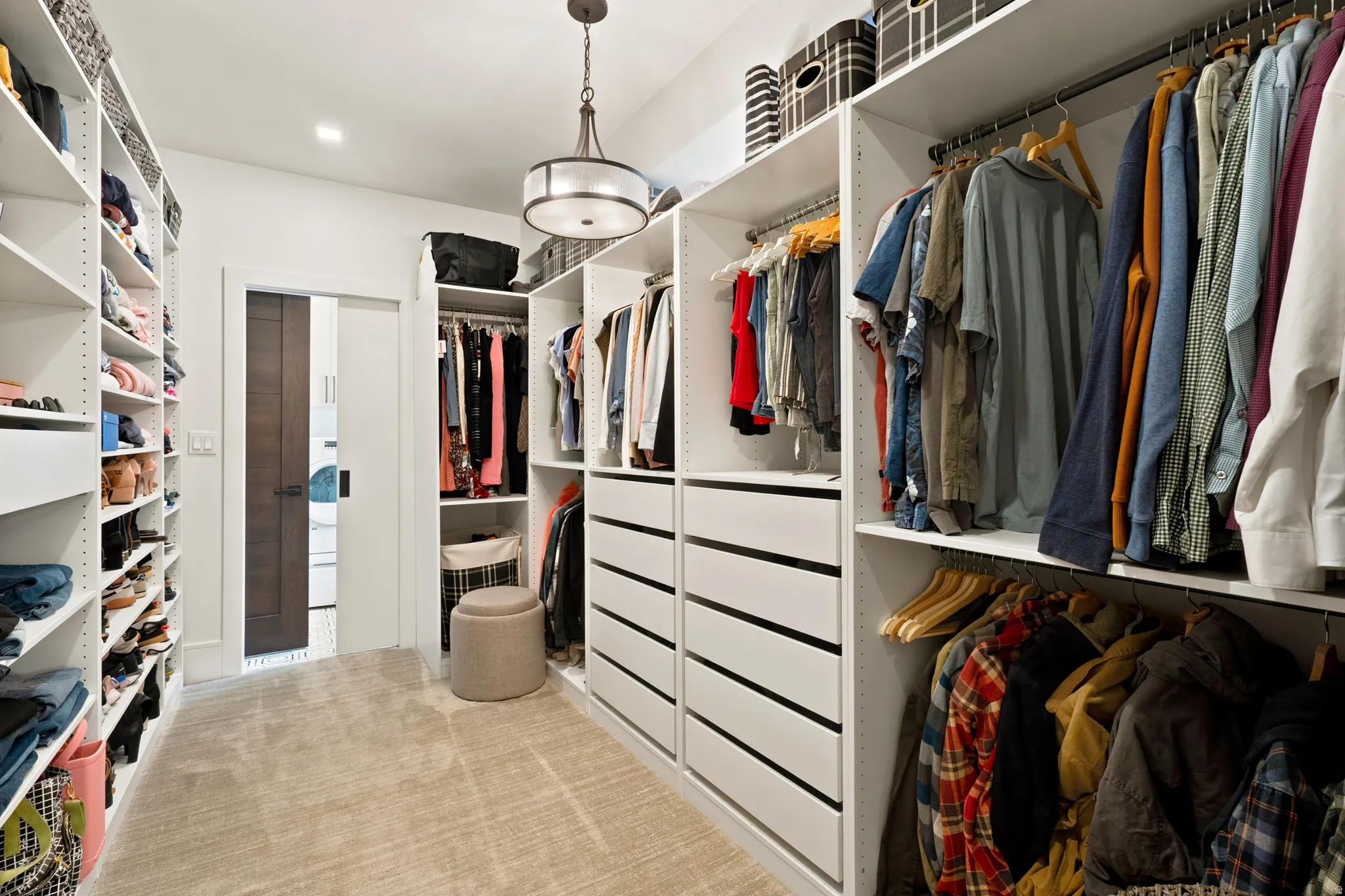 Customizable closet system with extensive shelving, multiple hanging rods, and built-in drawers
