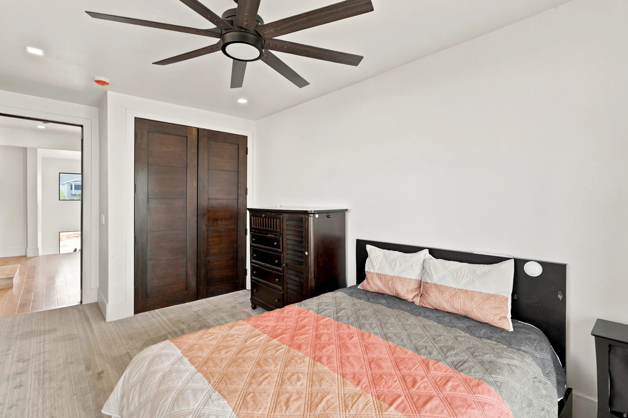 Bedroom featuring a ceiling fan with integrated lighting, recessed lighting, and light wood-finish flooring