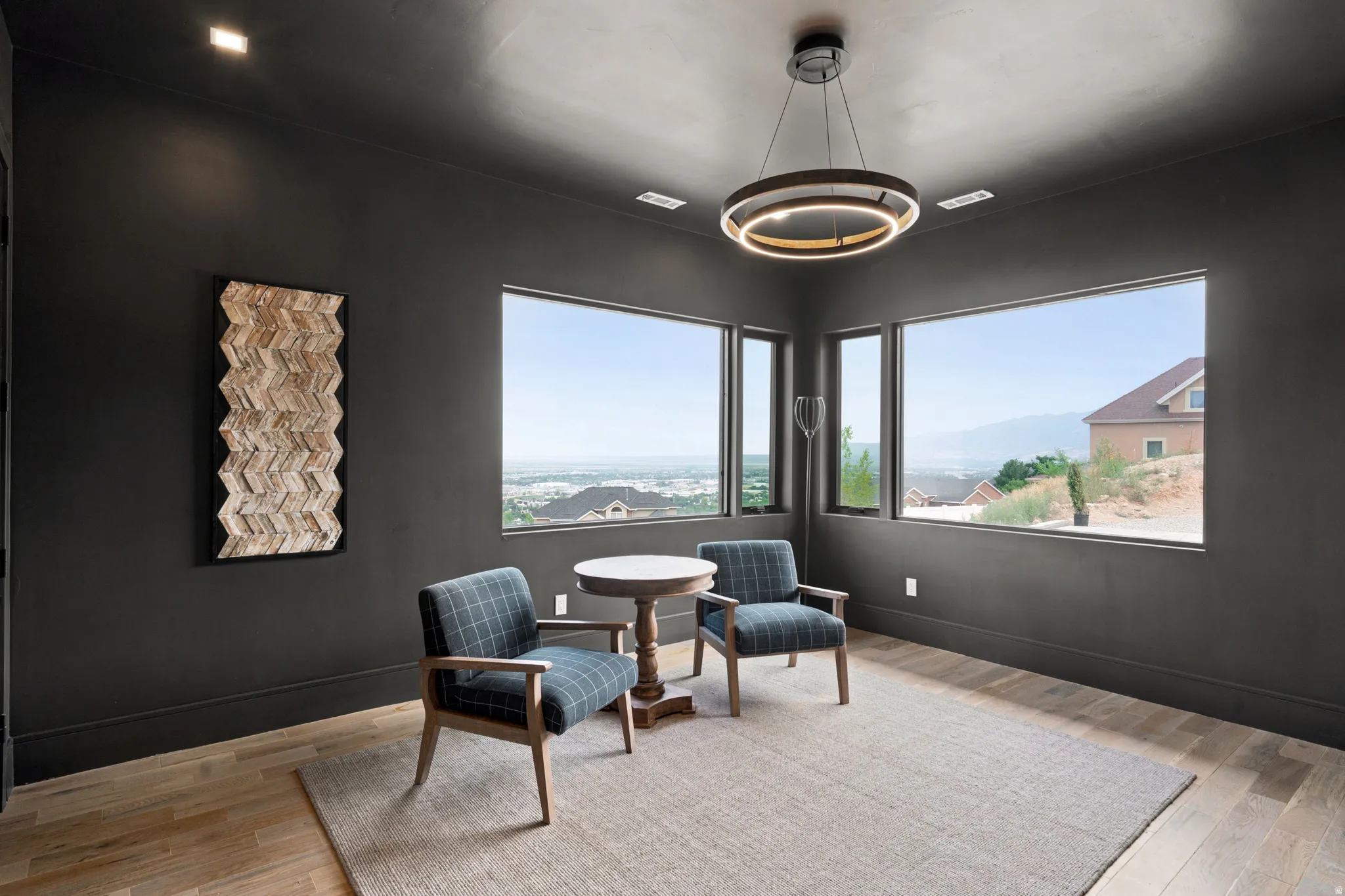 Room featuring expansive windows, recessed lighting, and a contemporary chandelier