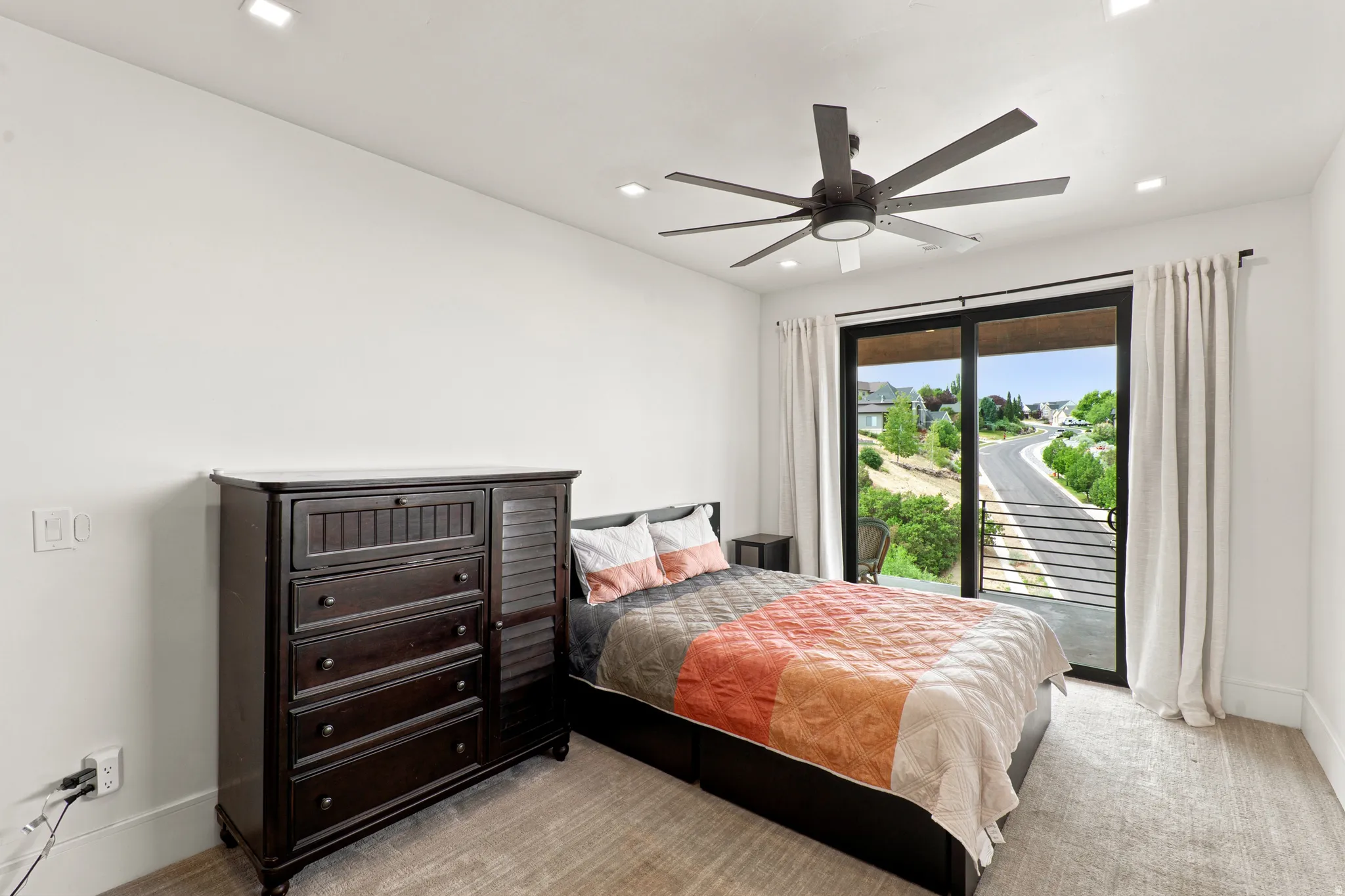 Bedroom with a large sliding glass door, recessed lighting, and a ceiling fan