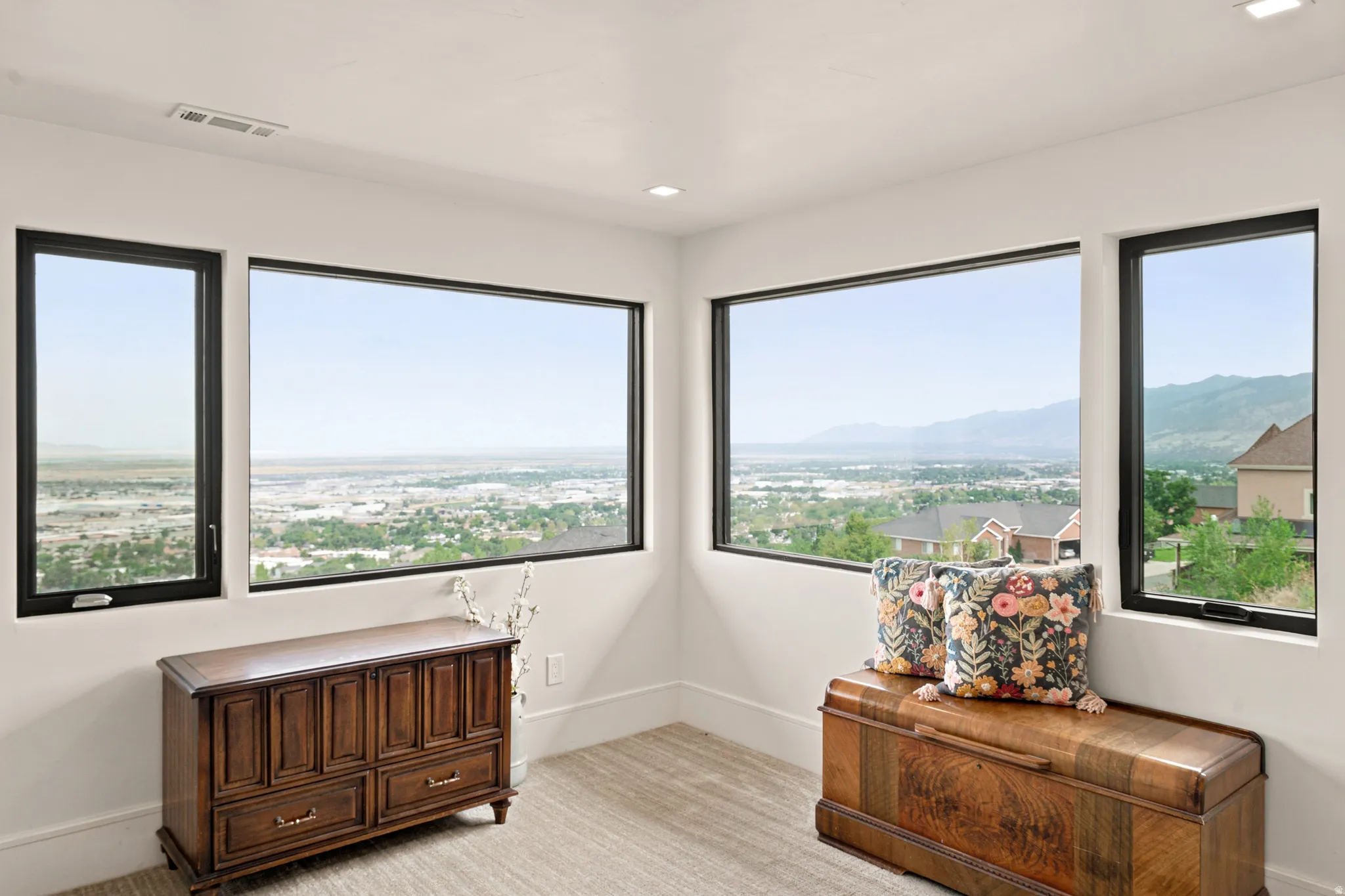 Expansive window arrangement with black frames, offering broad scenery