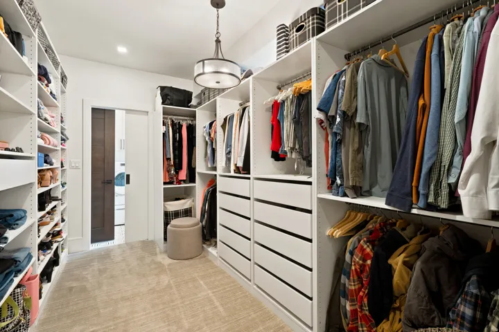 Customizable closet system with extensive shelving, multiple hanging rods, and built-in drawers