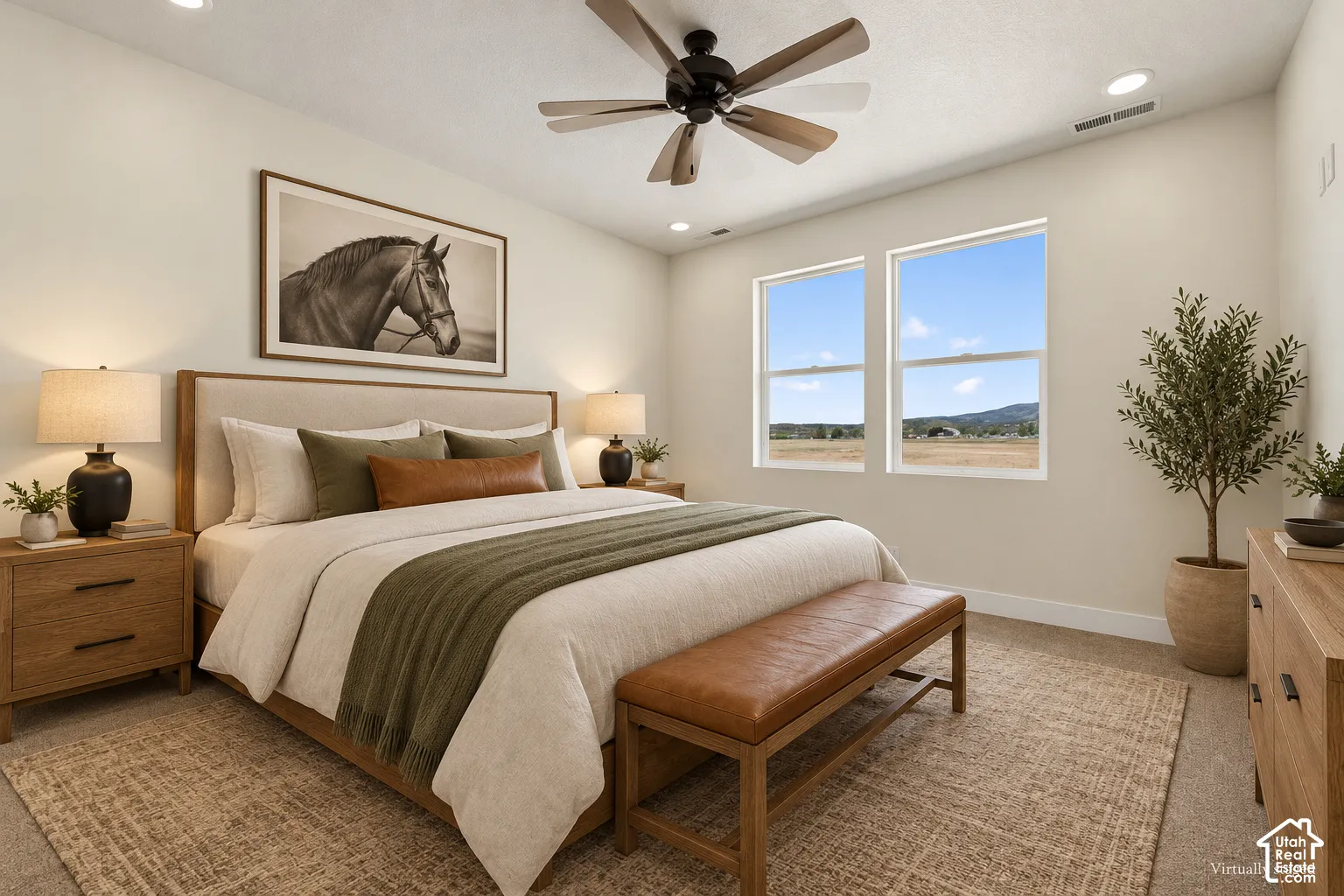 Neutral-toned room featuring recessed lighting, a multi-blade ceiling fan, and dual-pane windows offering rural landscape scenery