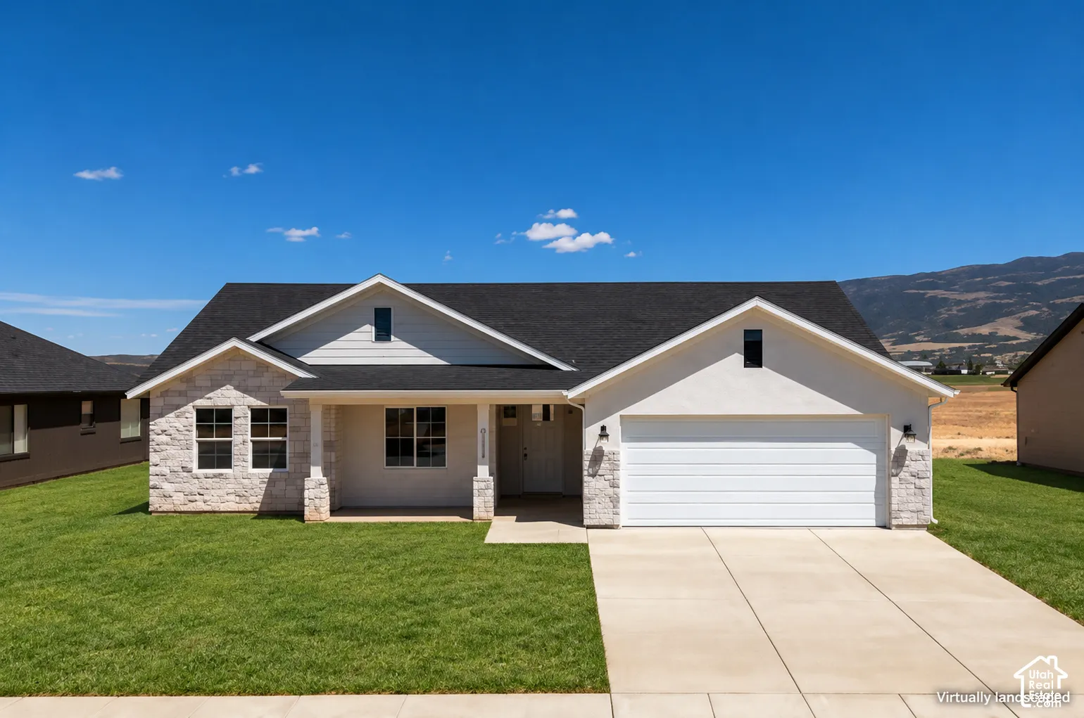 Single-story residence featuring stone veneer masonry, horizontal siding, a covered entryway, a two-car garage, and a mountain backdrop