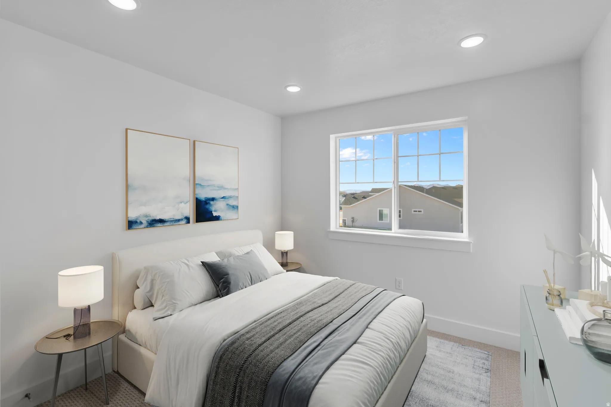 Bright bedroom featuring large multi-pane windows with natural light, recessed ceiling lighting, neutral wall finishes, and wood-finish flooring