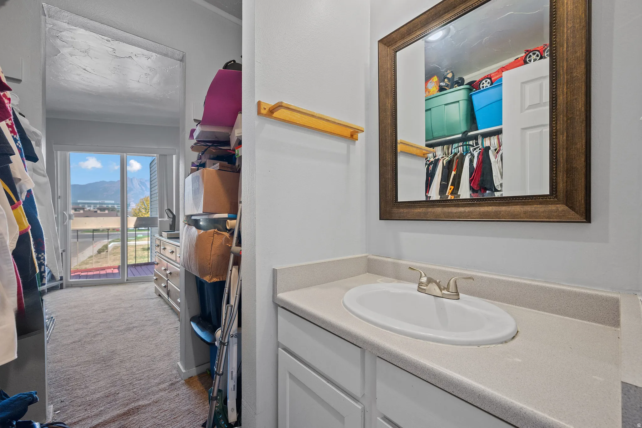Vanity with an integrated oval sink, chrome faucet, and framed mirror