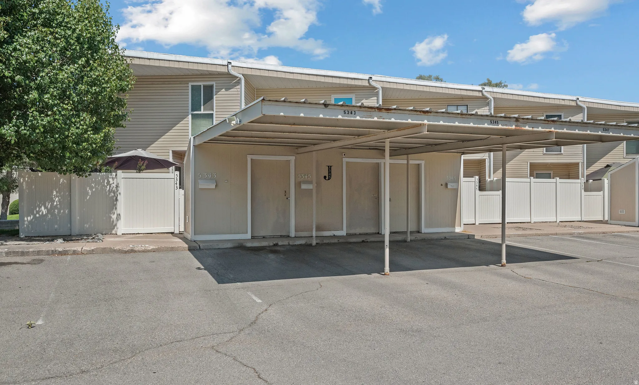 Carport parking structure providing covered vehicle accommodation