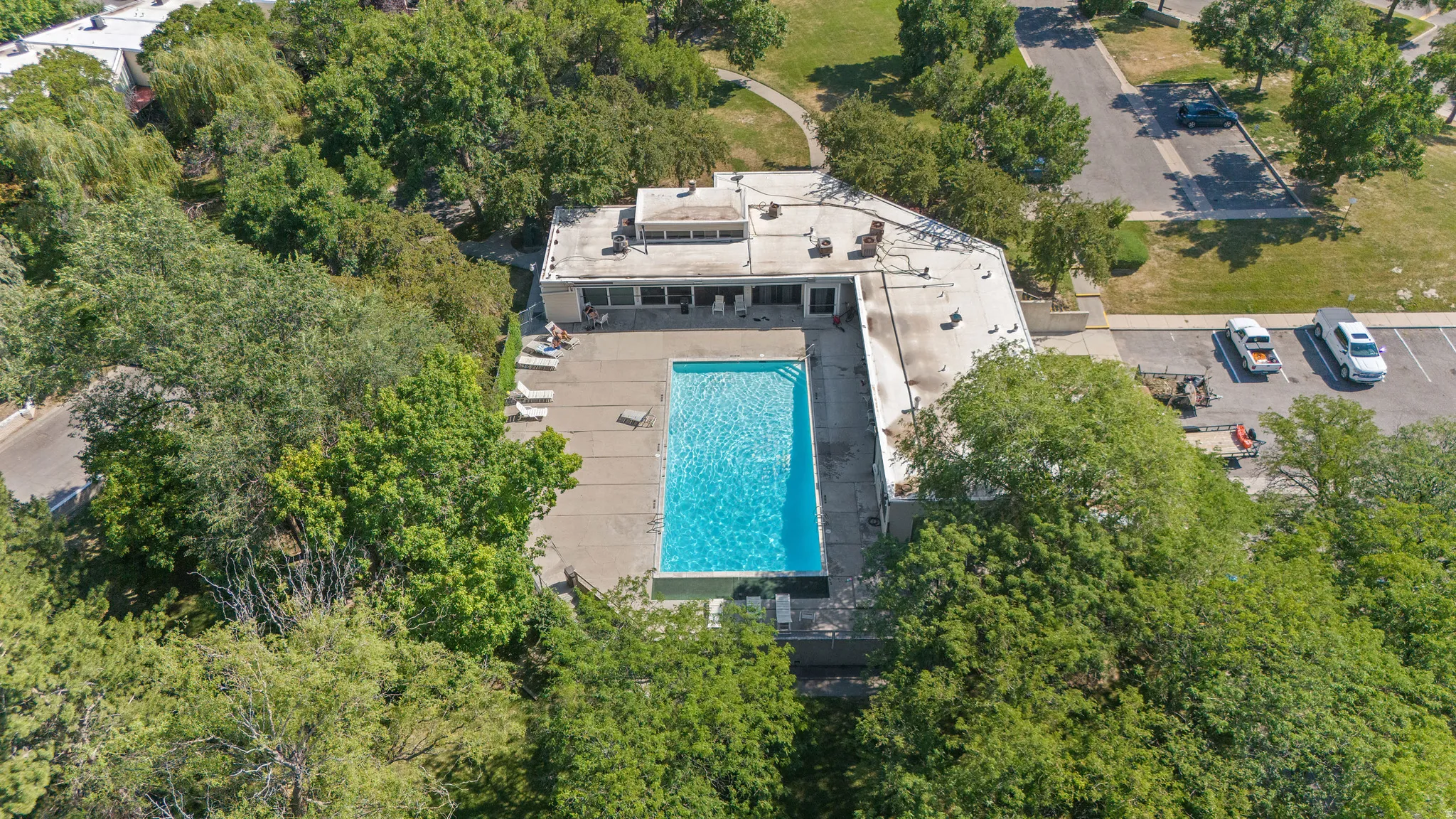 Outdoor swimming pool surrounded by a concrete deck