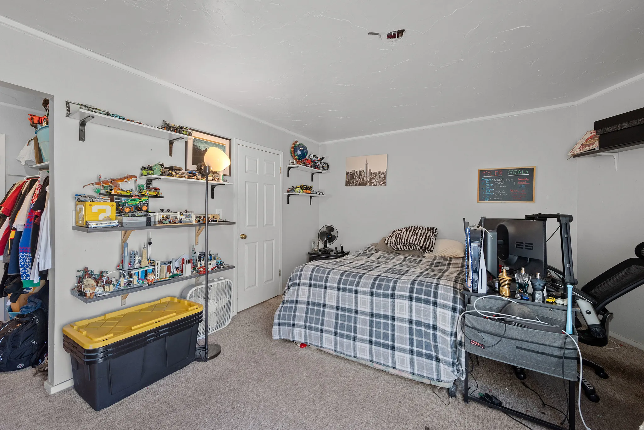 Carpeted room with light gray walls, white trim, and a white interior door