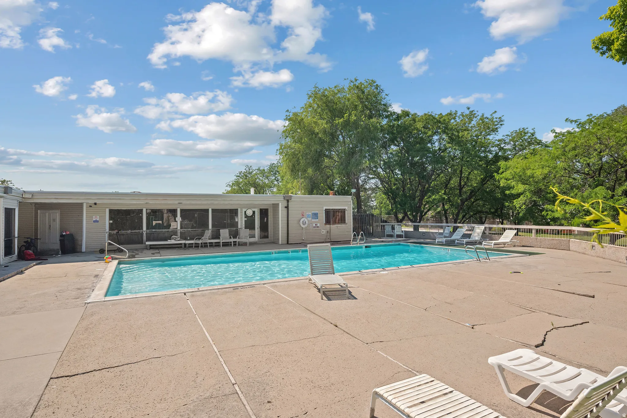 Rectangular swimming pool surrounded by a concrete deck