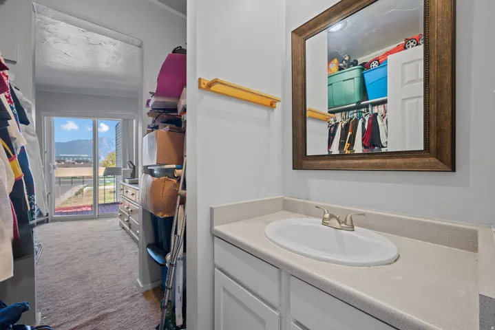 Vanity with an integrated oval sink, chrome faucet, and framed mirror