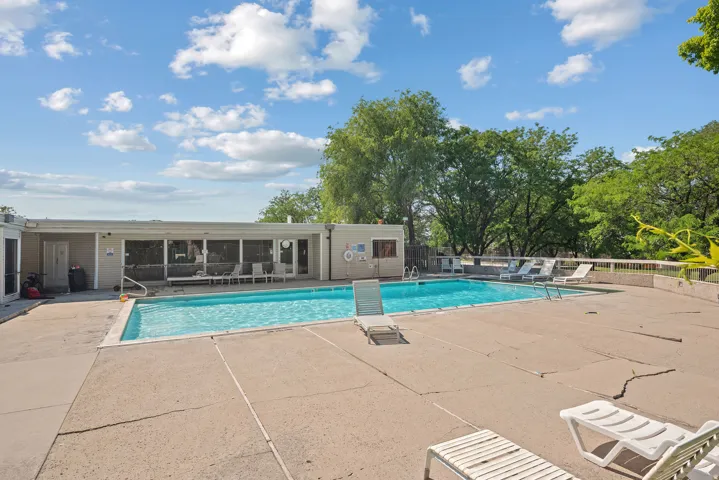 Rectangular swimming pool surrounded by a concrete deck