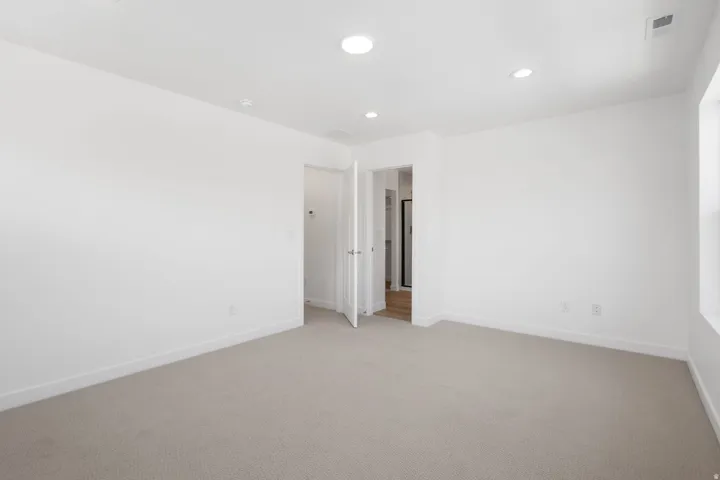 Carpeted room featuring recessed lighting, a white painted interior, white trim, and a window providing natural light