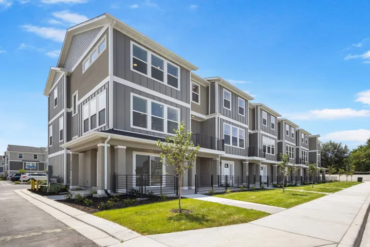Contemporary multi-story townhome featuring a board and batten facade