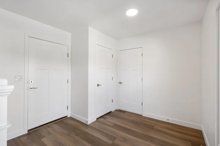 Entry area featuring wood-finish flooring, crisp white walls, and a recessed ceiling light