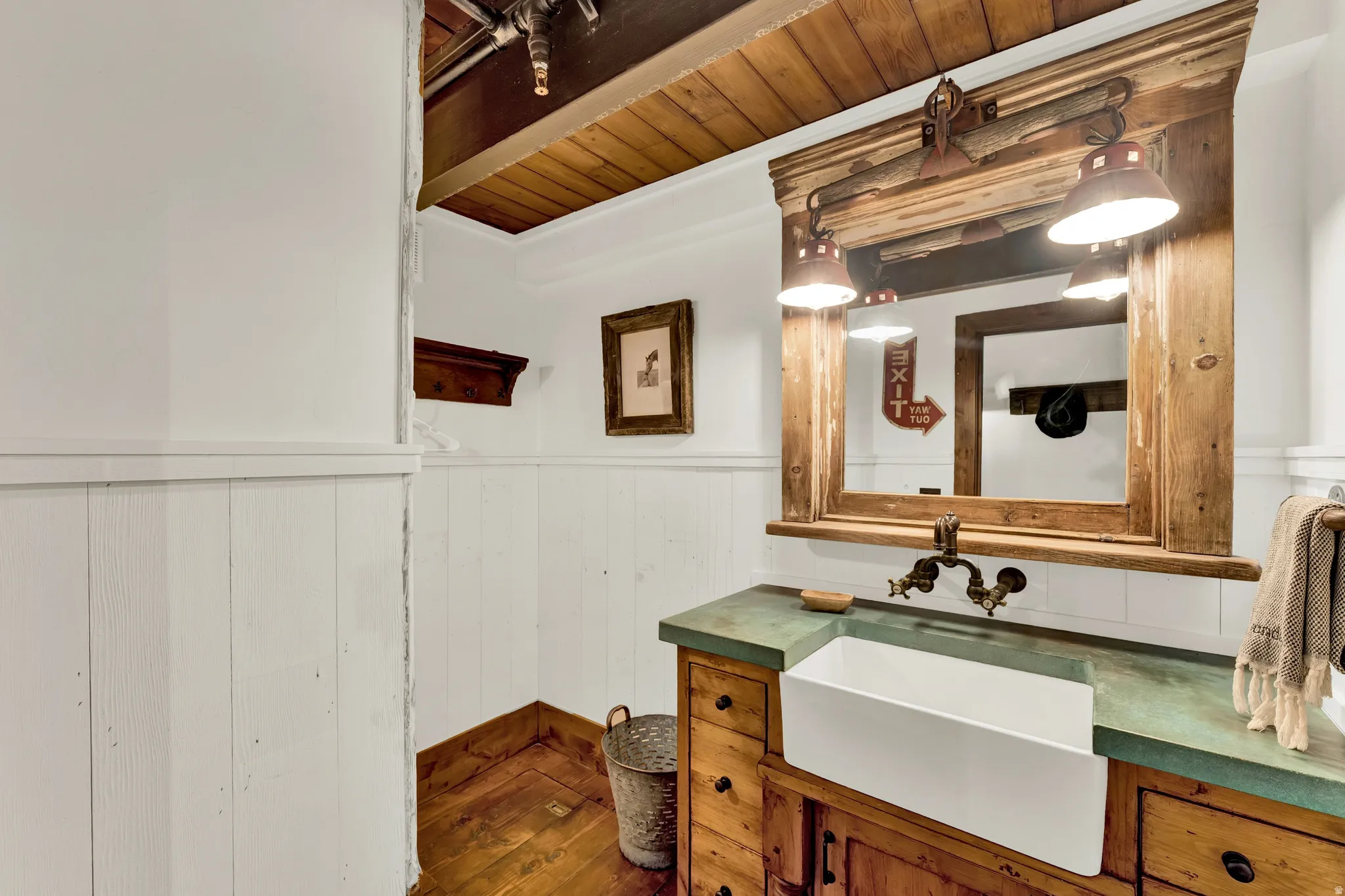 Elegant primary bathroom showcasing shiplap wainscoting, wood-finish vanity with dual vessel sinks, green quartz countertop, and oil-rubbed bronze faucetry