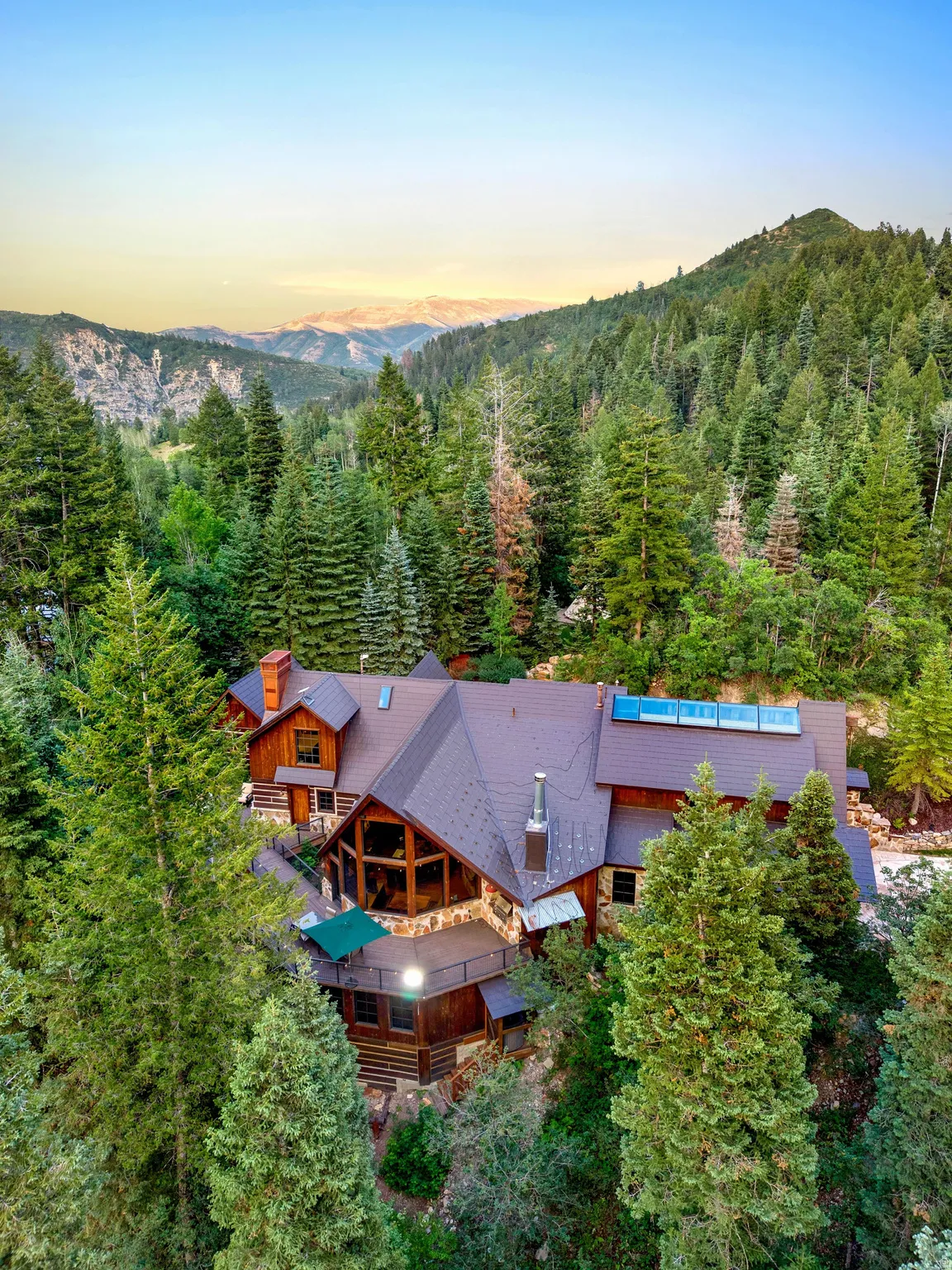 Striking timber-frame residence nestled within mature evergreen forest