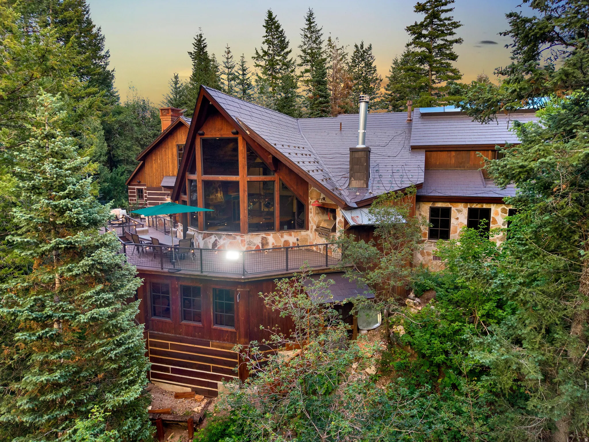 Modern timber-frame residence nestled within mature evergreen forest