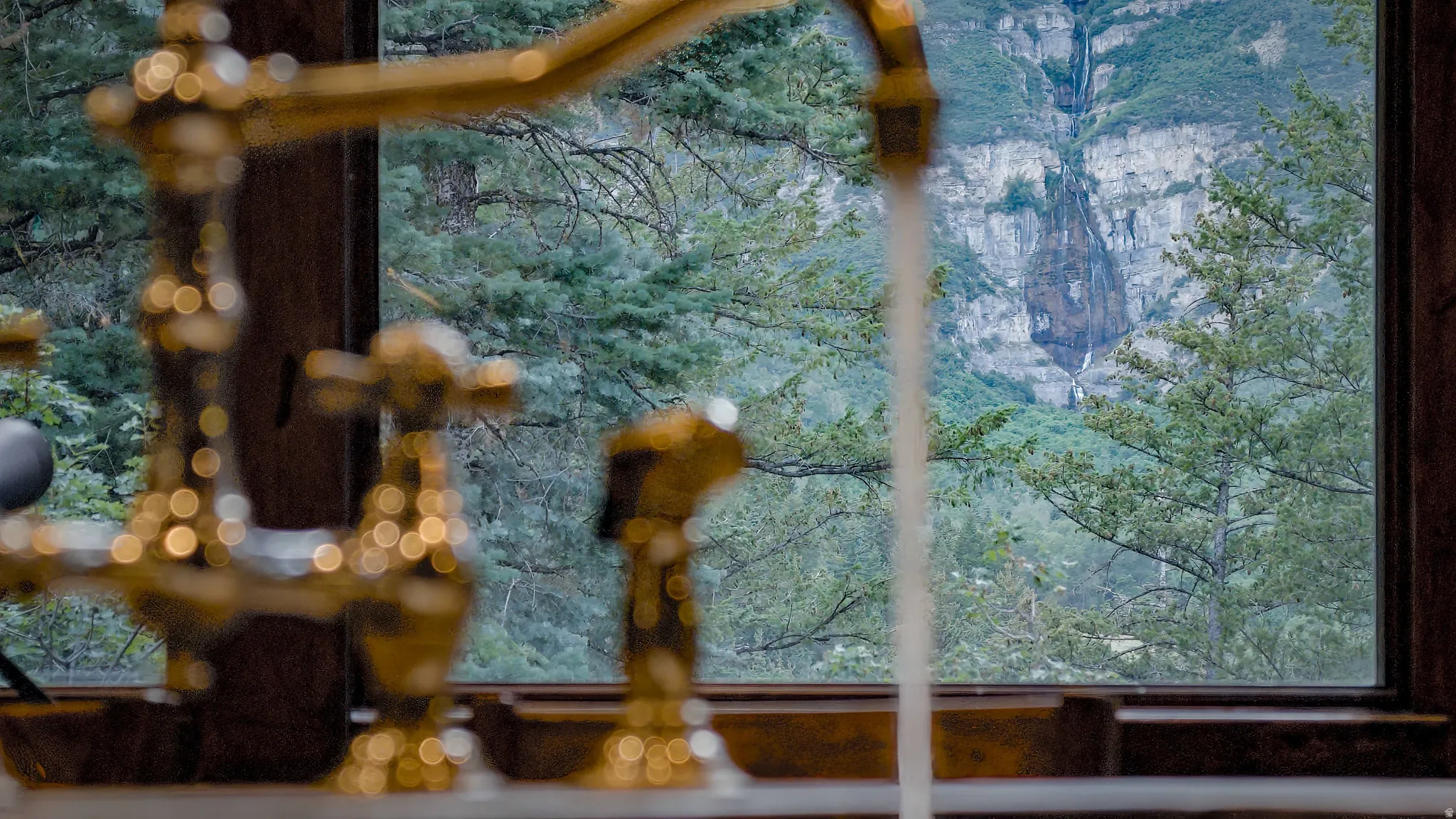 Window with a mountain and waterfall backdrop