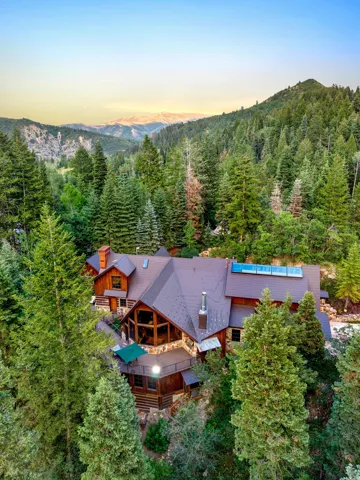 Striking timber-frame residence nestled within mature evergreen forest