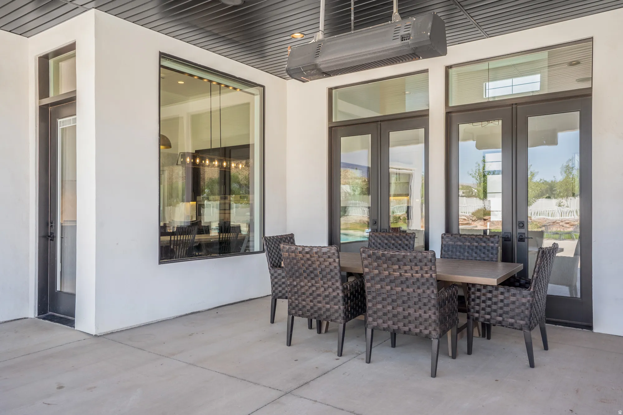 Covered patio featuring a concrete slab and a built-in overhead heater