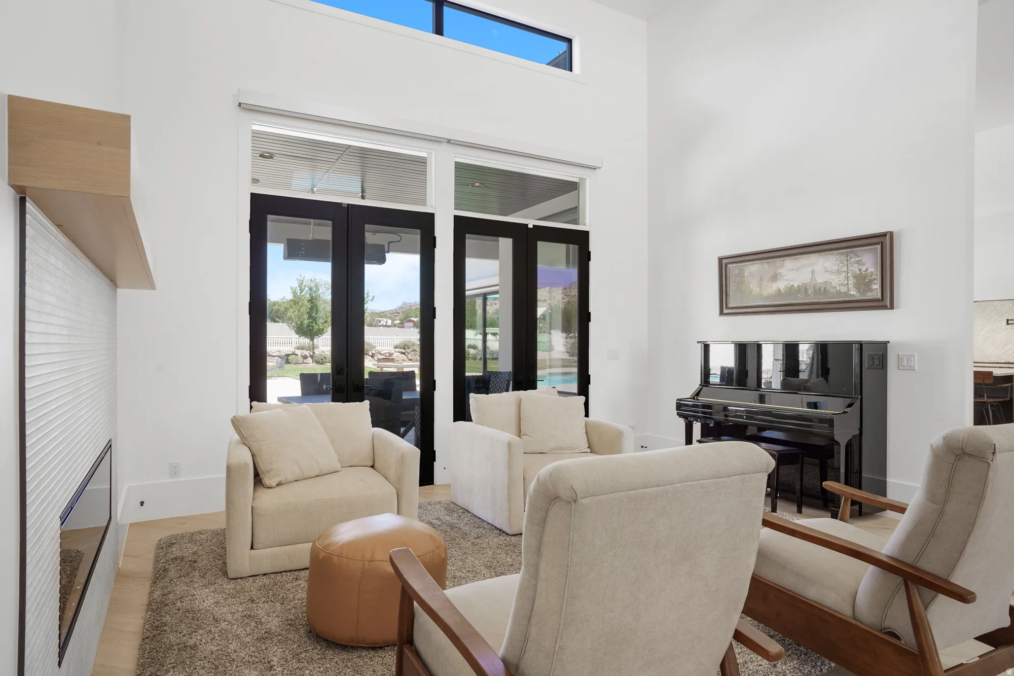 Spacious living area featuring high ceilings and large glass patio doors