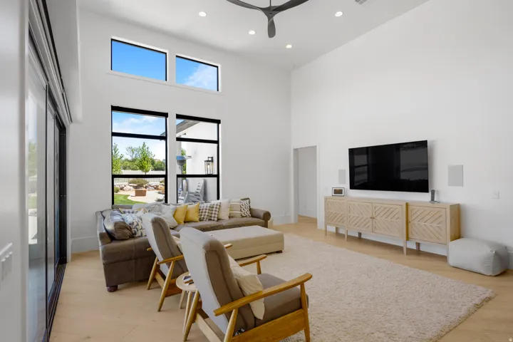 Spacious living area featuring high ceilings, recessed lighting, and light wood-finish flooring