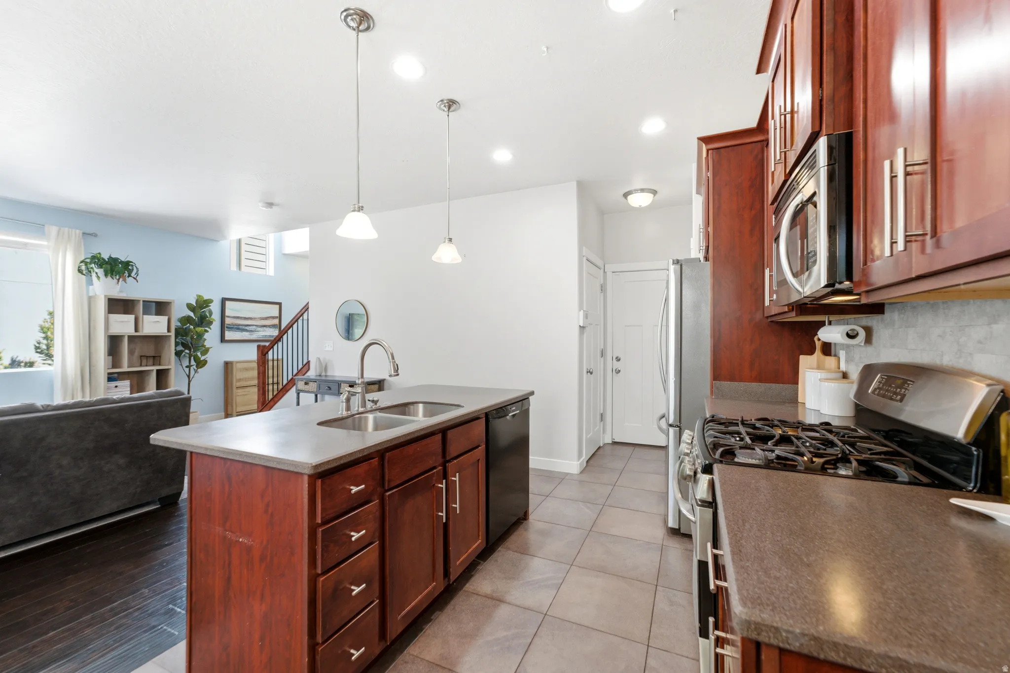 Chef's kitchen featuring rich wood cabinetry, stainless steel gas range, and professional-grade appliances