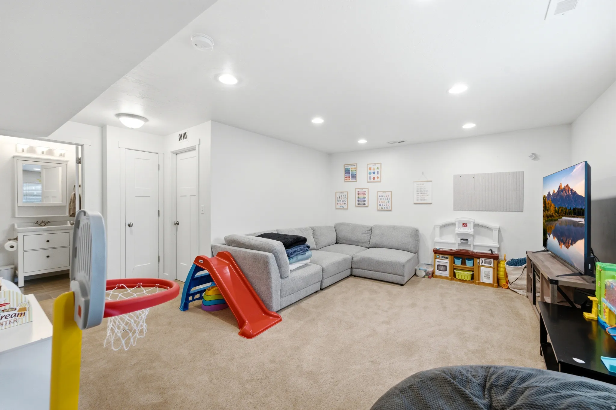 Spacious recreation room featuring neutral carpet flooring, recessed ceiling lighting, and ample square footage ideal for flexible use