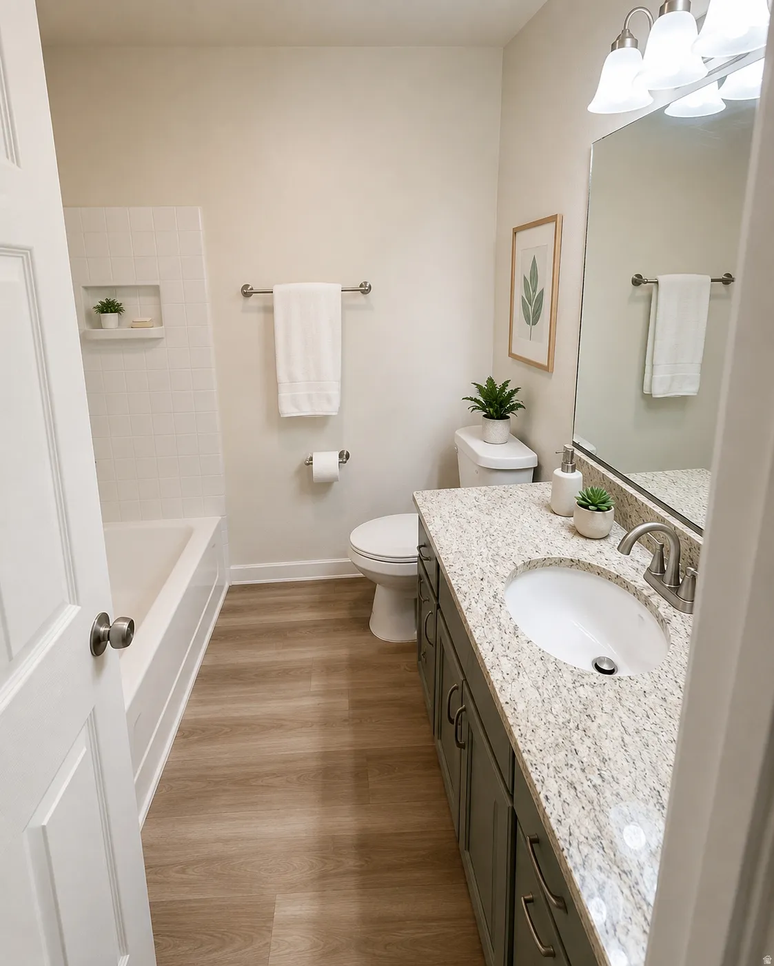 Spacious bathroom featuring a dual-sink vanity with speckled quartz countertop, brushed nickel fixtures, and ample storage cabinetry
