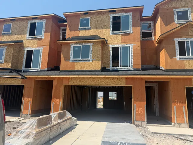 Modern multi-unit residential building featuring warm terracotta and golden-toned exterior finishes with clean geometric lines