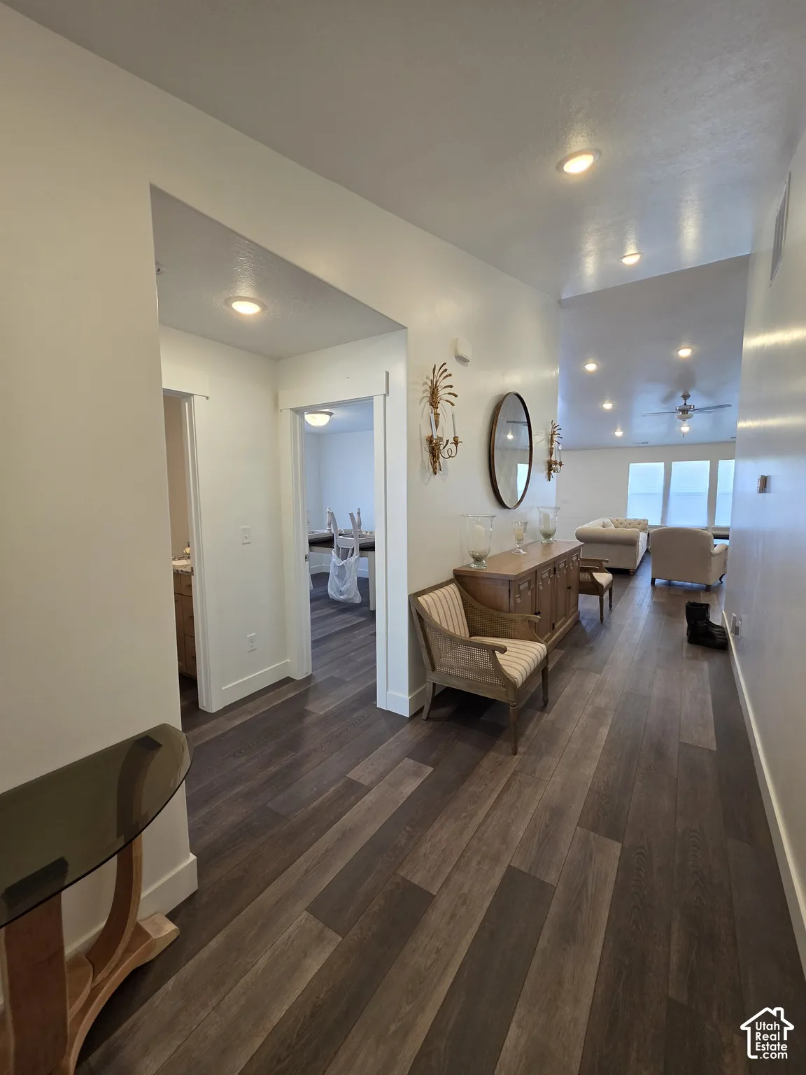 Spacious hallway featuring wide plank wood-finish flooring, recessed lighting, and white trim