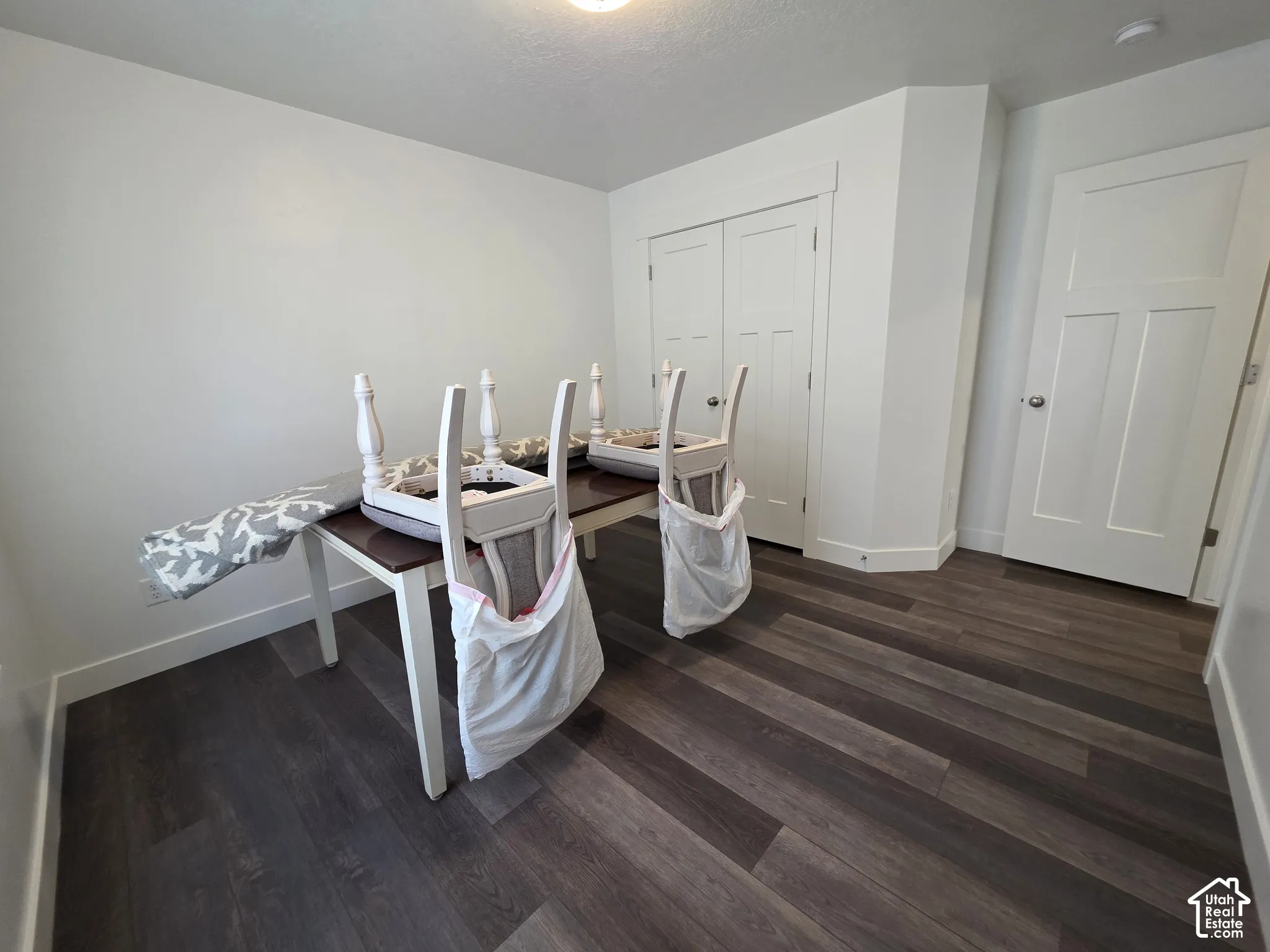 Contemporary flooring in a rich wood-tone finish enhances this versatile room