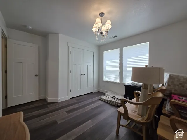 Room featuring wood-finish flooring, white trim, and two panel doors