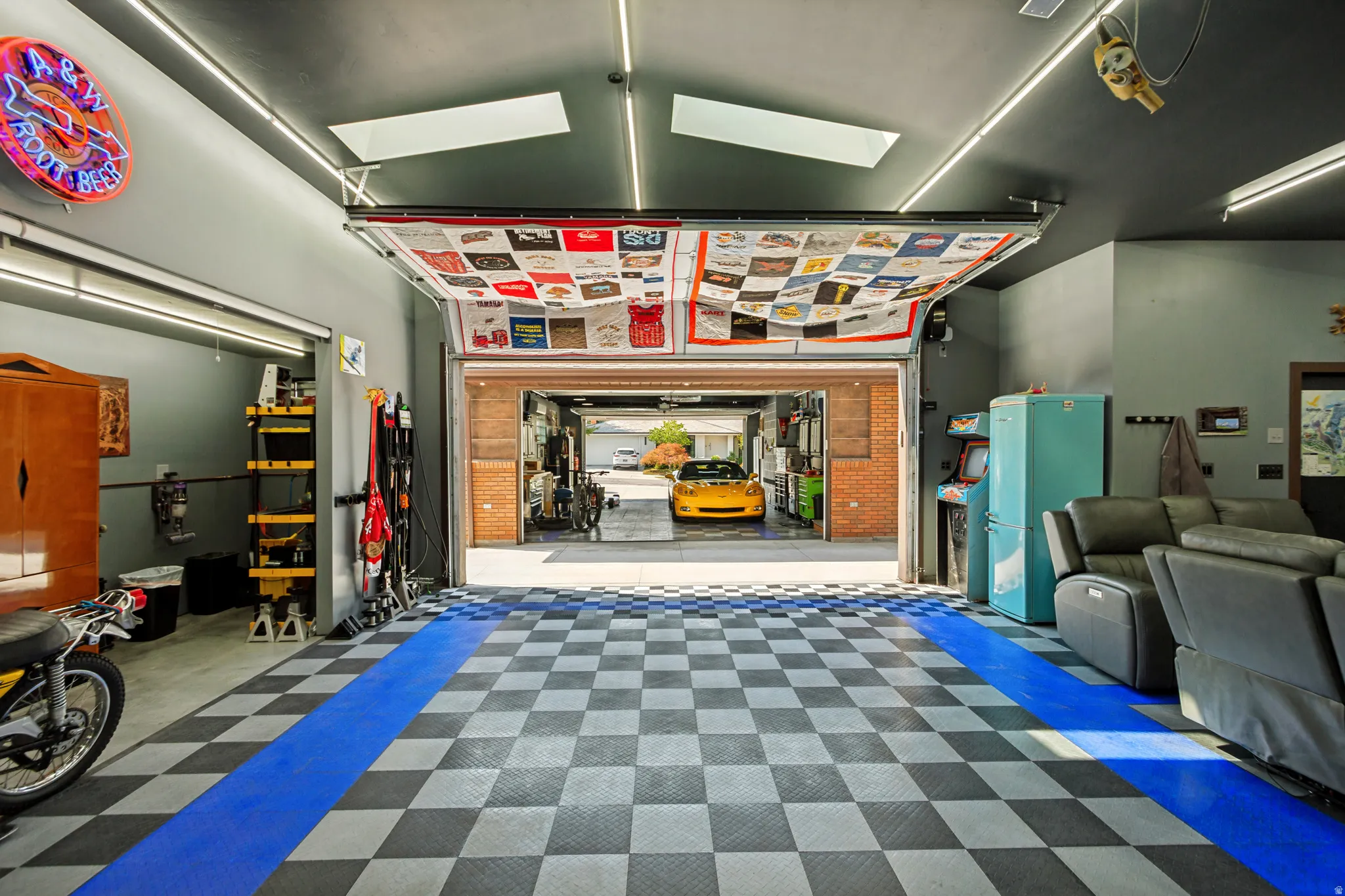 Detached rear Workshop/Garage, approximately 948 sq ft.and features insulated overhead doors, professionally installed copper compressed-air lines around the perimeter, a dedicated ventilated room for grinding and sanding, durable black, gray, and blue ch