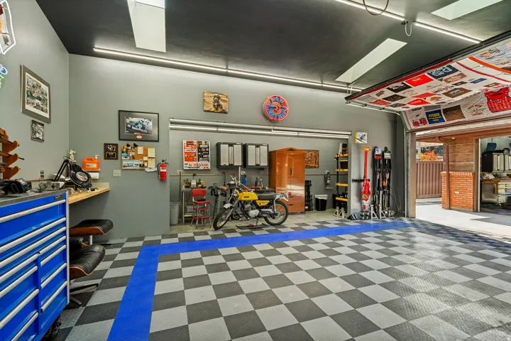Detached rear Workshop/Garage, approximately 948 sq ft.and features insulated overhead doors, professionally installed copper compressed-air lines around the perimeter, a dedicated ventilated room for grinding and sanding, abundance of electrical outlets.