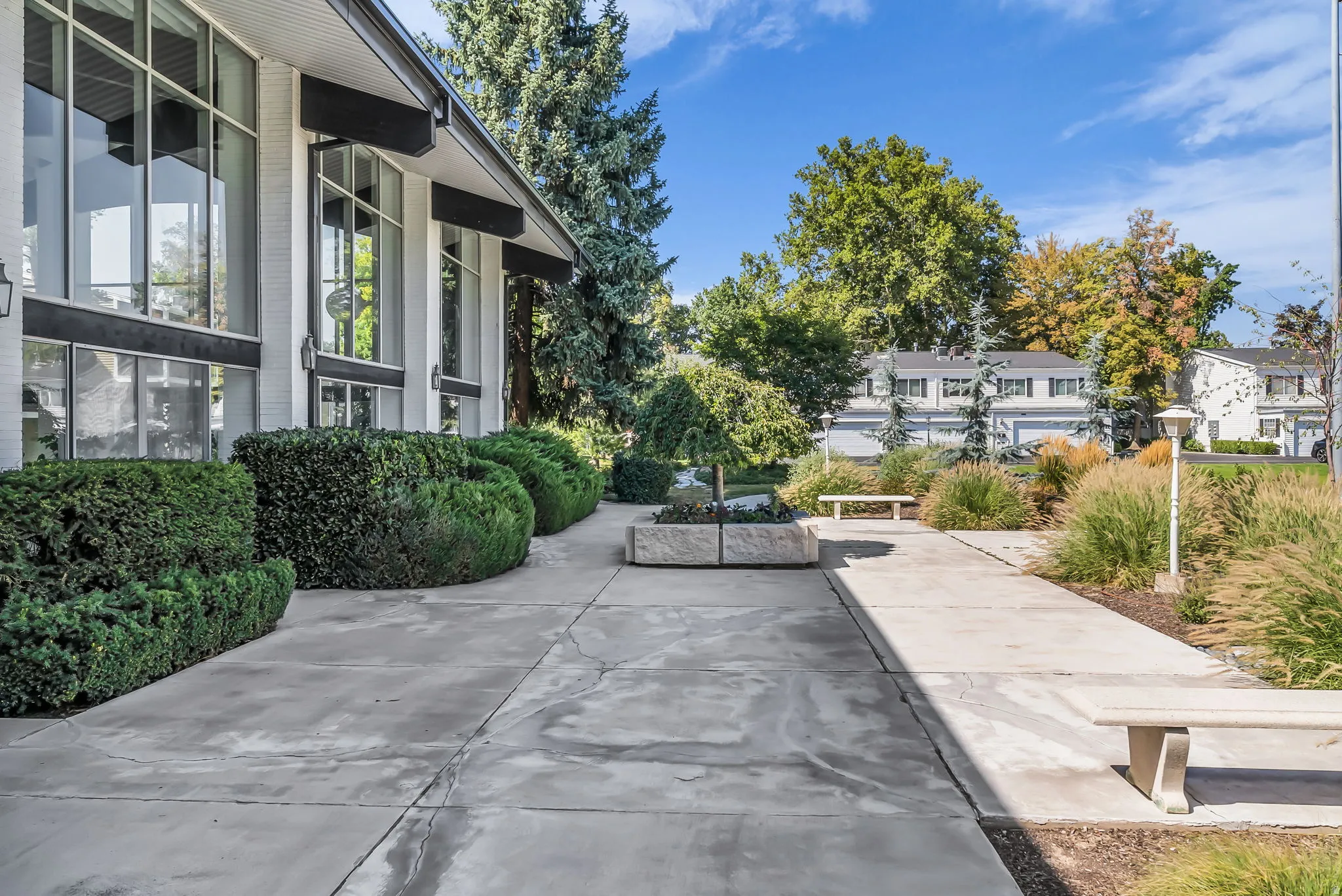 Modern architectural exterior with a sophisticated concrete patio featuring clean lines and seamless hardscaping