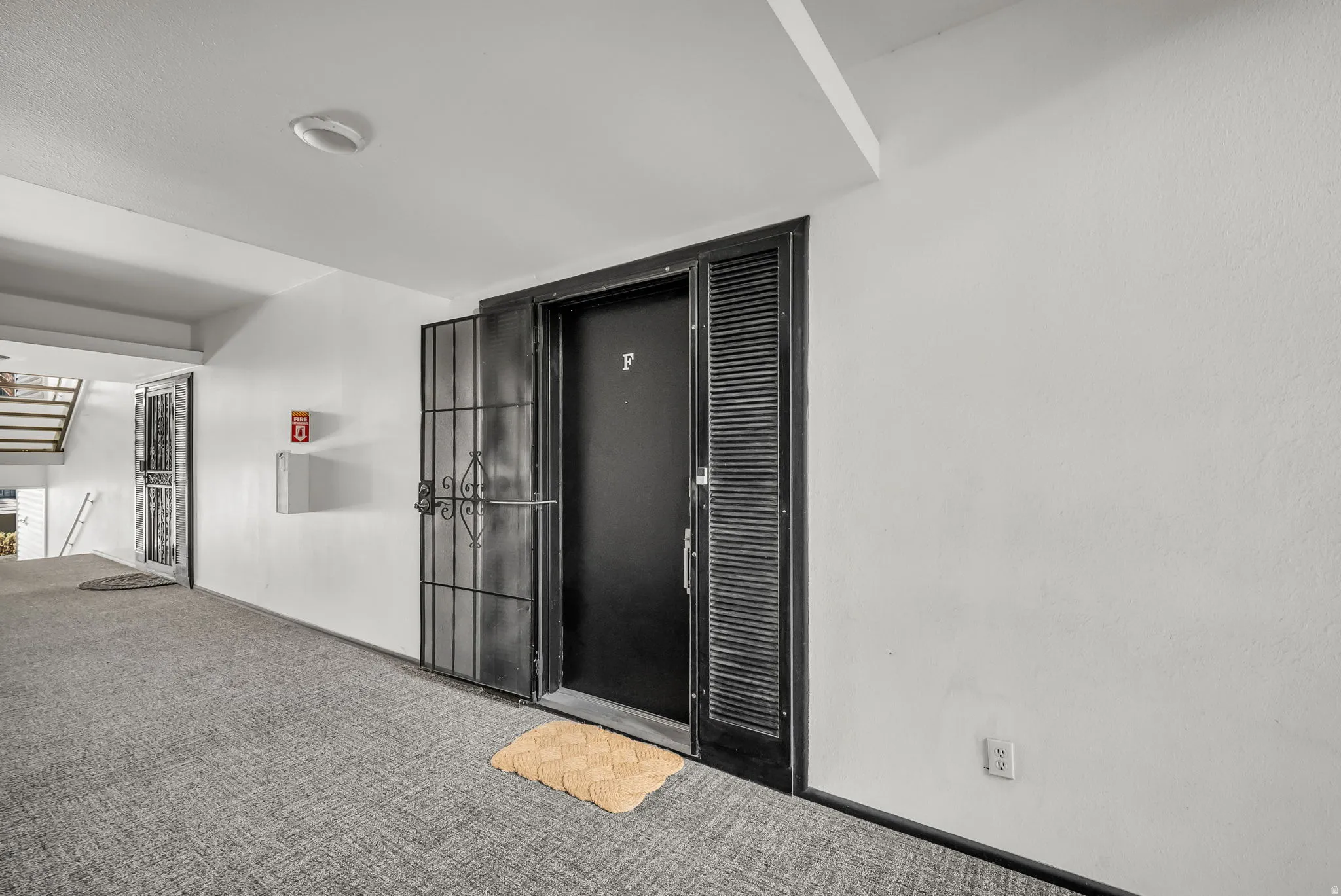 Modern corridor featuring polished concrete flooring, clean white walls, and recessed ceiling lighting